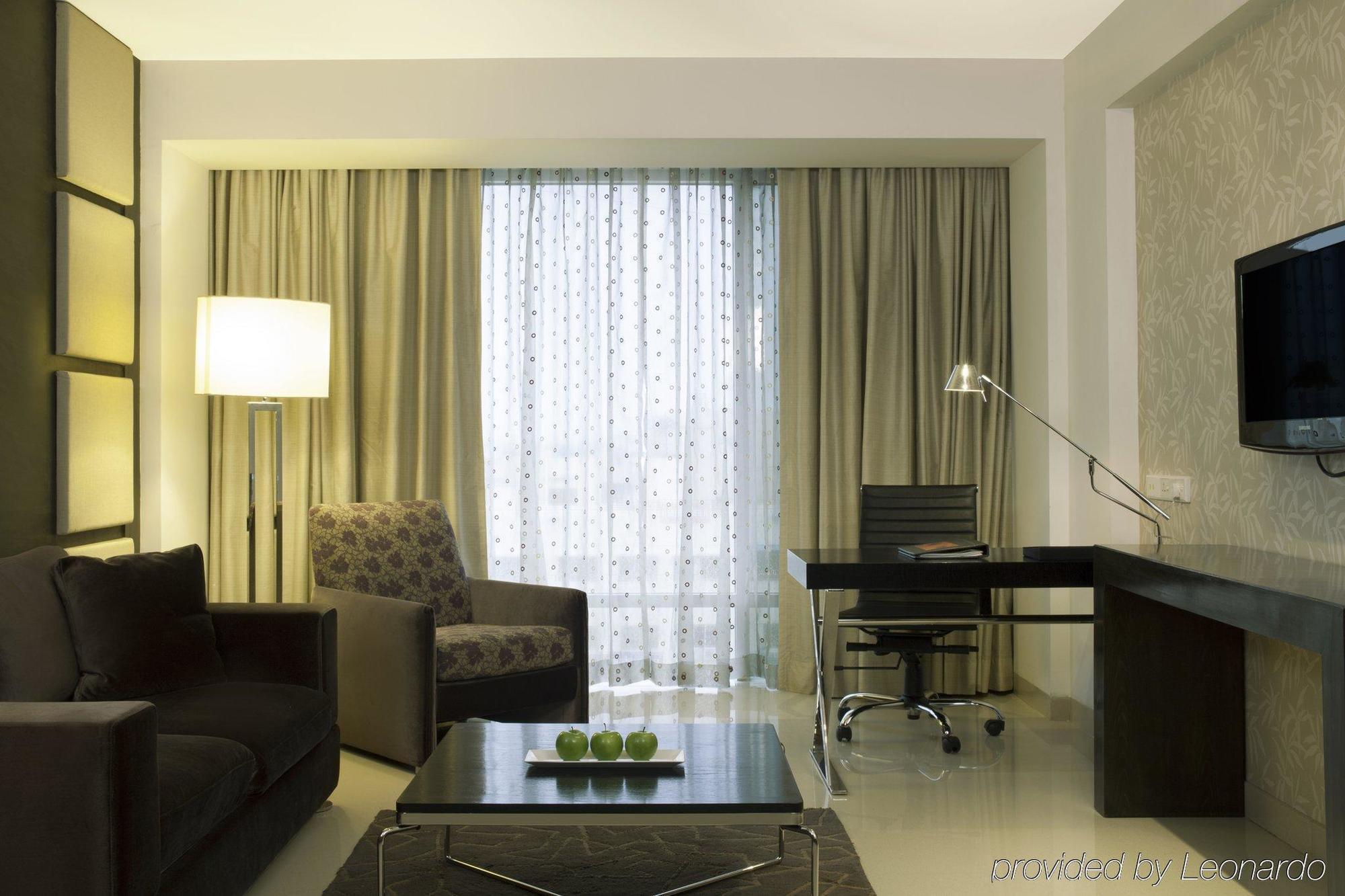 Radisson Blu Hotel Pune Kharadi Exterior photo A living room in a suite at the hotel